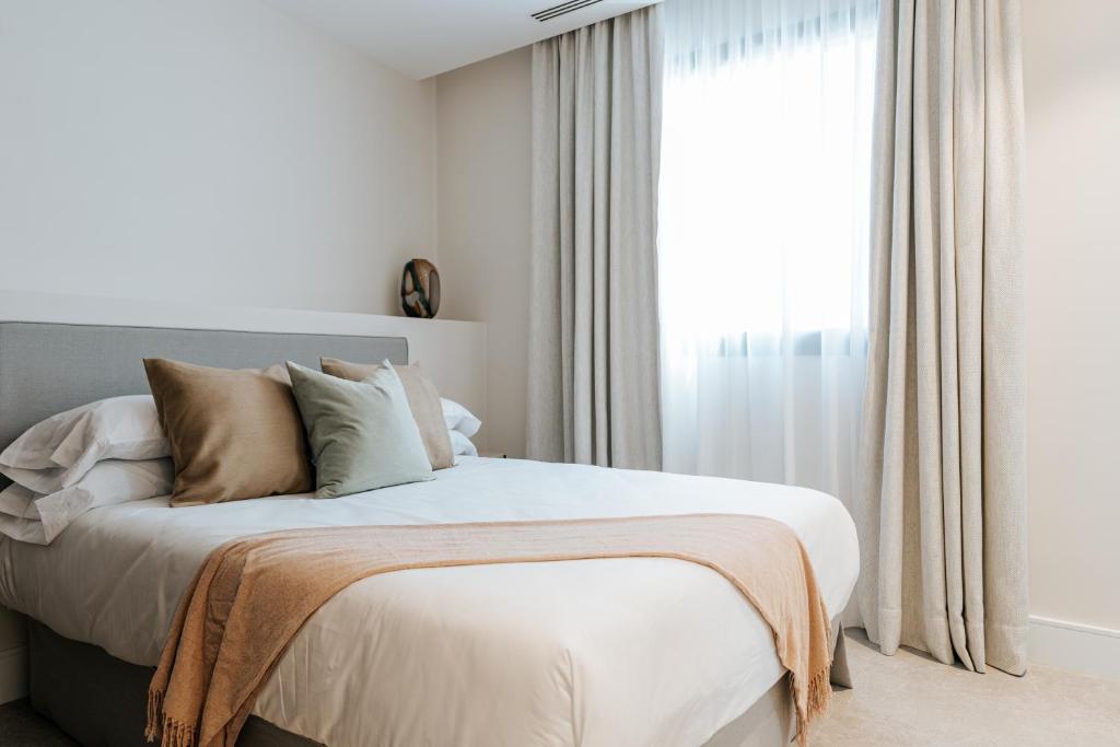 a bedroom with a large bed with a window at Dock 1 Suites in Santa Cruz de Tenerife