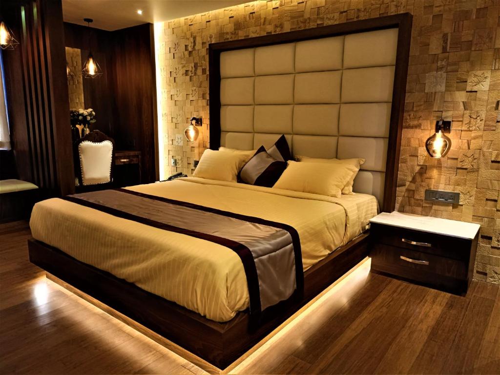 a bedroom with a large bed with a large headboard at Retrieve Health & Wellness in Cochin