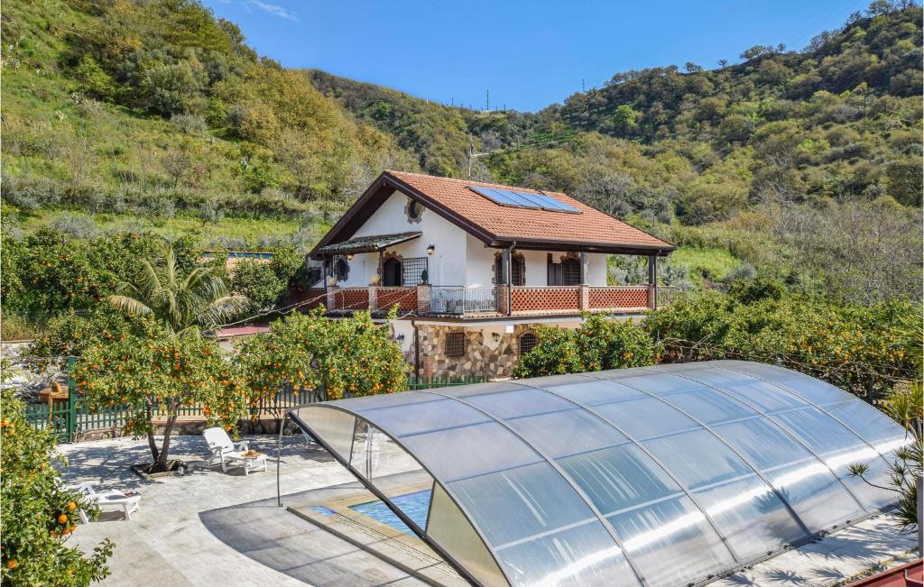 une maison avec une serre en face d'une montagne dans l'établissement Gorgeous Home In Gaggi With Swimming Pool, à Gaggi