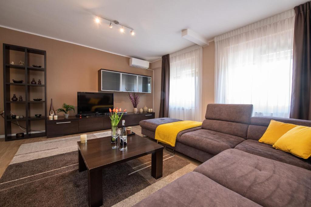 a living room with a couch and a tv at Apartman Sanja Opatija in Opatija