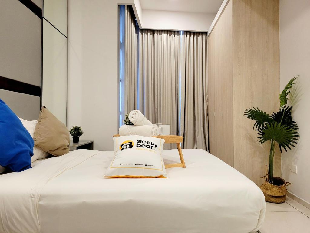 a hotel room with a bed with a teddy bear on it at Robertson Suites by Sleepy Bear, Bukit Bintang in Kuala Lumpur