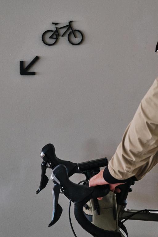 a person riding a bike with a clock on the wall at Helios Mallorca Hotel & Apartments in Can Pastilla