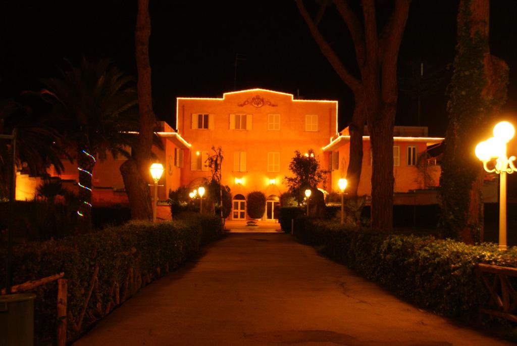 a house at night with lights on a street at DEPENDANCE PARCO dei PRINCIPI in Anzio