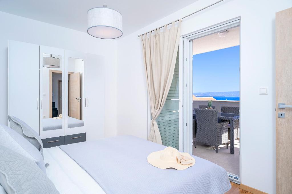 a bedroom with a bed and a view of the ocean at Apartments Mistral in Bol