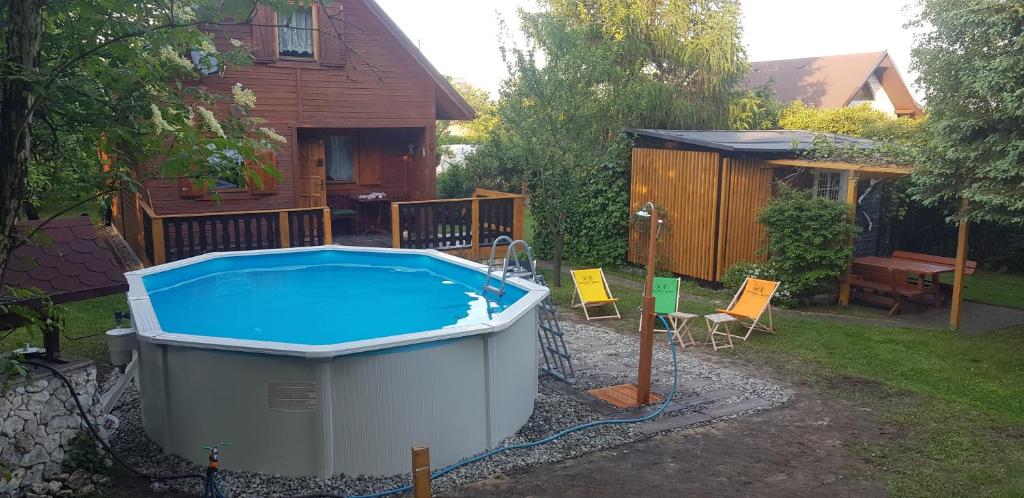 a pool in the backyard of a house at Szyszka i Róża Domek na Jurze in Zelasko