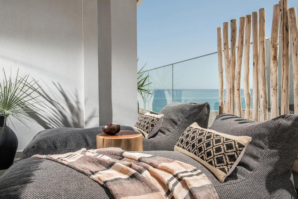 een woonkamer met een bank en een tafel bij Khroma Luxury Suite 2 Beach front apartment in Chersonissos