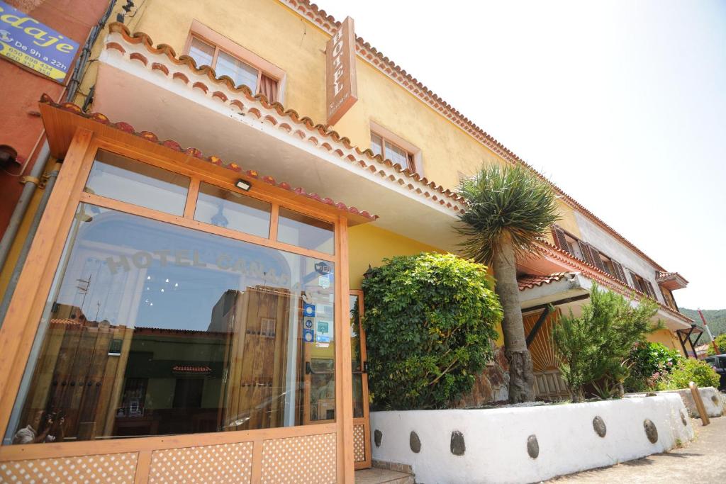 a building with a palm tree in front of it at Hotel Las Cañadas in La Esperanza
