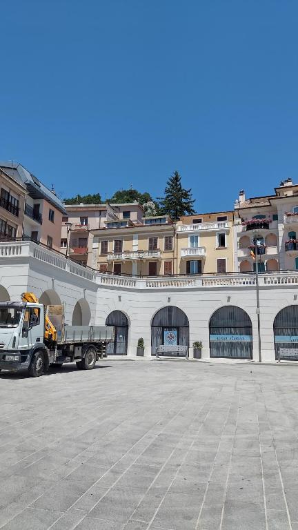 a dump truck parked in front of a building at Piccolo paradiso in pieno centro Castel di Sangro in Castel di Sangro