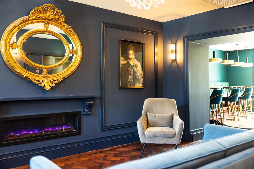 a living room with a chair and a mirror at Magmell Townhouse in Wicklow