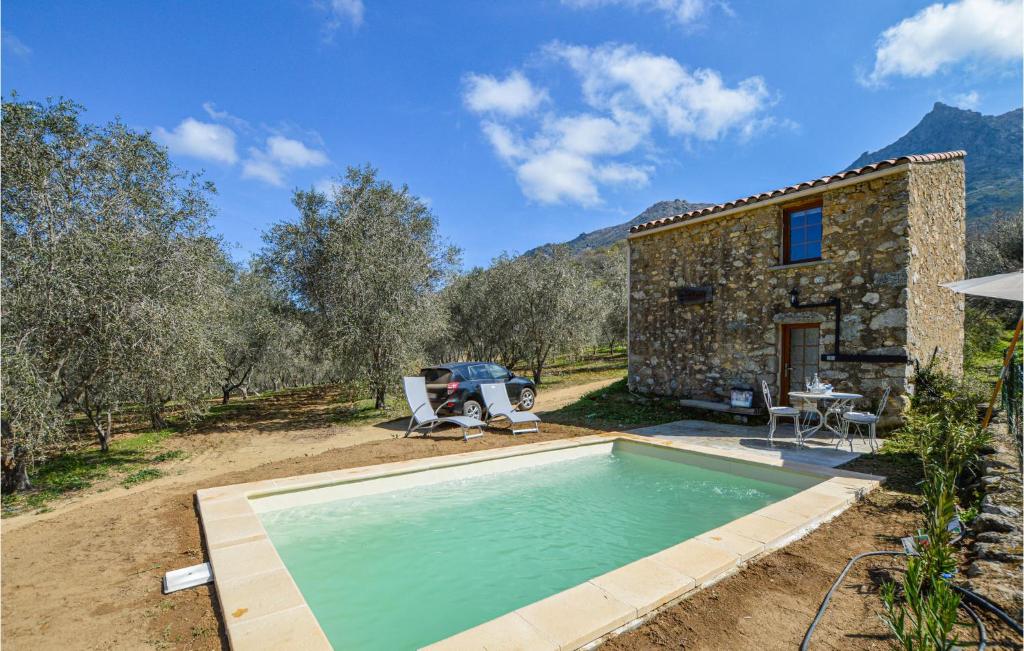 um chalé de pedra com uma piscina em frente em Amazing Home In Feliceto With Kitchenette em Feliceto