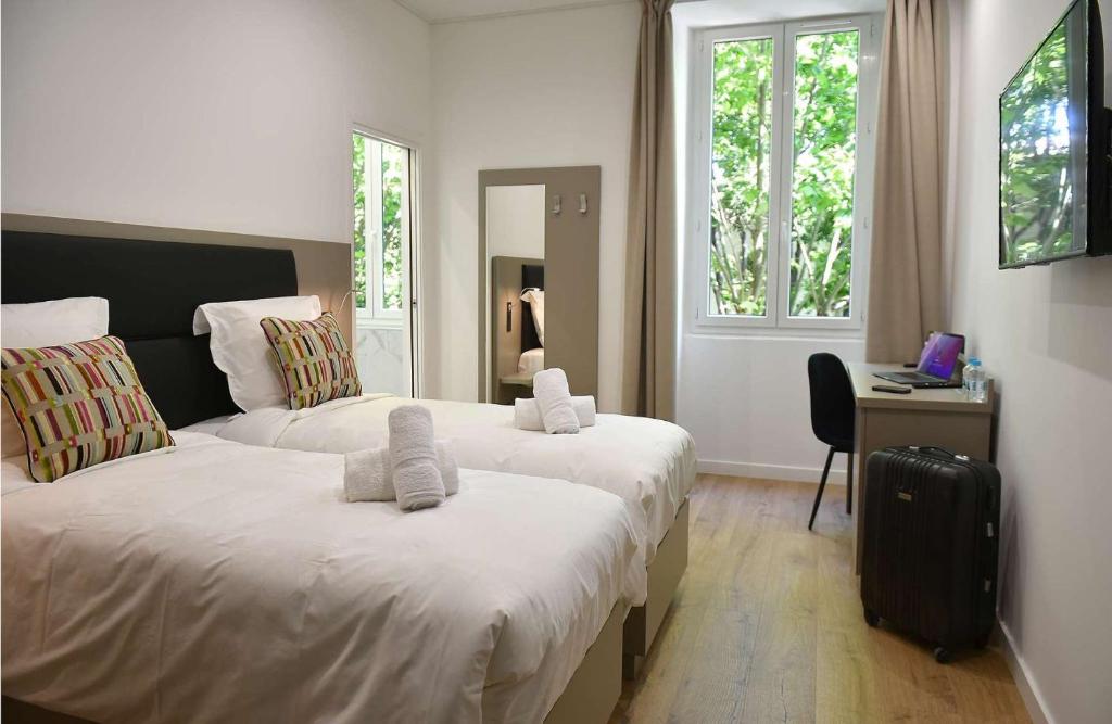 Posteľ alebo postele v izbe v ubytovaní Hôtel Continental