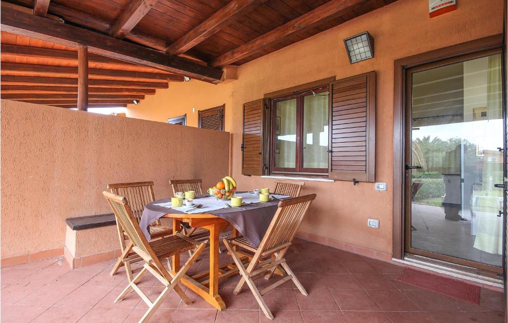 a dining room table with chairs on a patio at Trilo Beach in Monte Nai