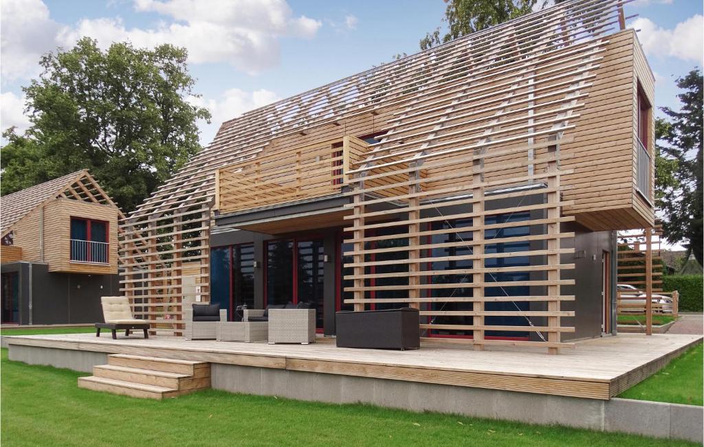 a large wooden building with a bench in a yard at Haus 9 in Wendorf