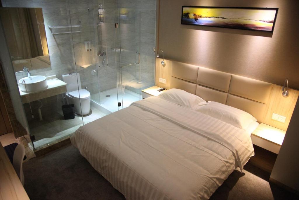 a bedroom with a shower and a bed and a sink at Shanghai Fish Inn East Nanjing Road in Shanghai