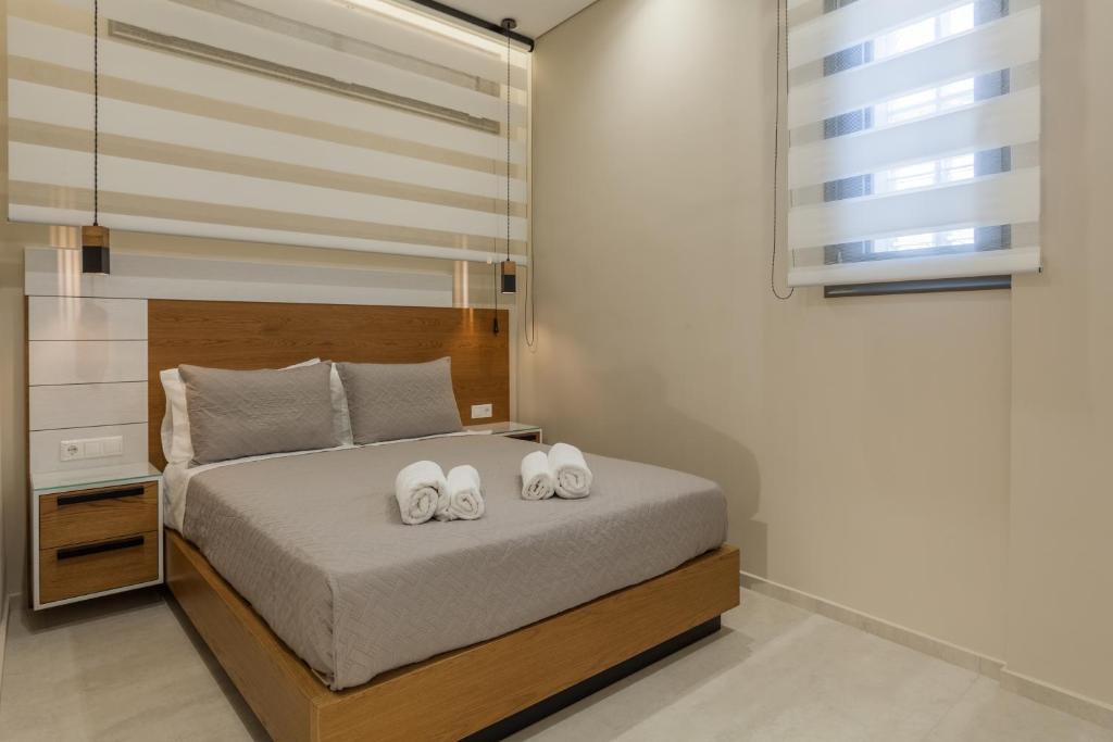 a bedroom with a bed with two towels on it at Athena Apartment in Heraklio Town