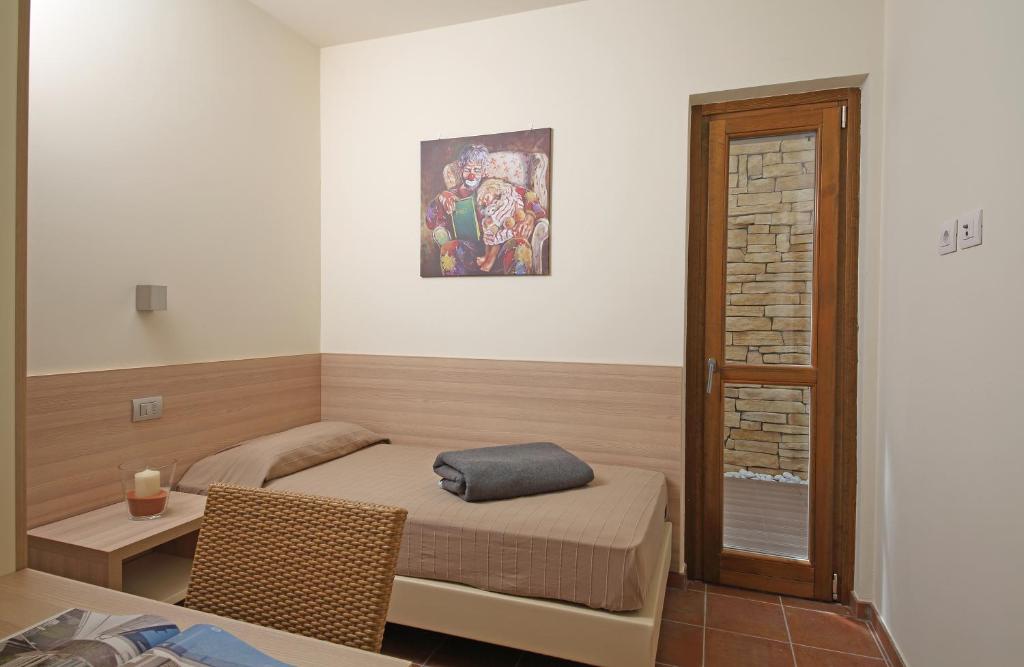 Postel nebo postele na pokoji v ubytování Appartamenti Corte Leonardo