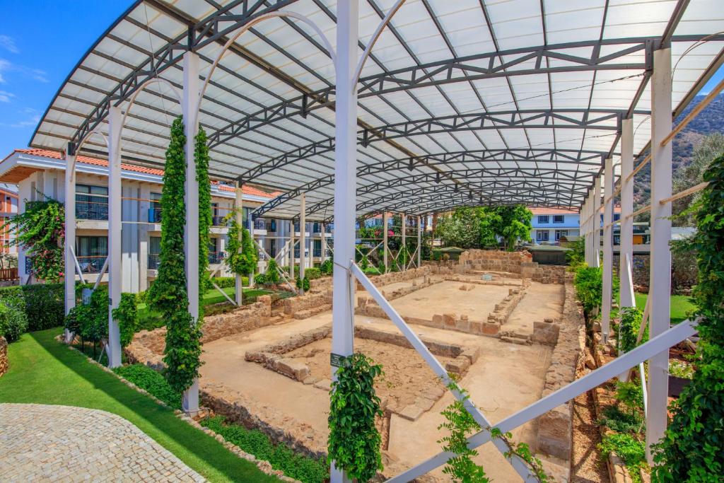 a greenhouse in a school with trees and plants at Ecclesia Hotel - Adult Only (+14) in Oludeniz