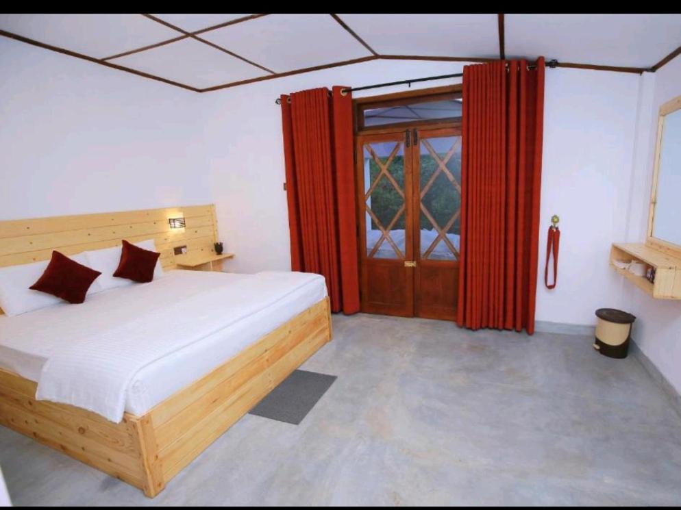 Postel nebo postele na pokoji v ubytování Wingate Homestay
