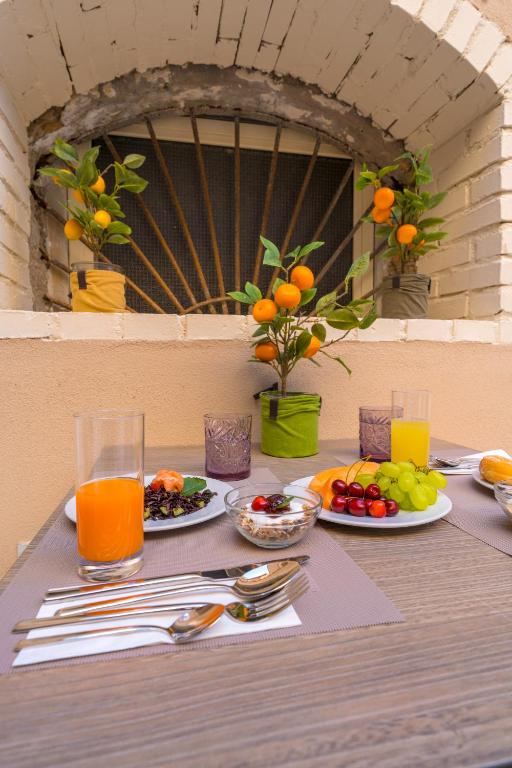 a table with plates of food and fruit on it at ELISEO PALACE TROPEA in Tropea