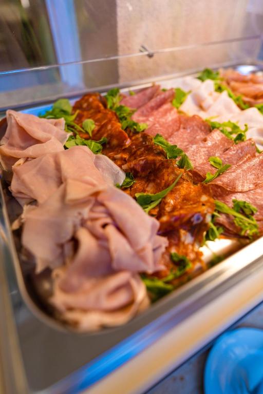 a tray of food with meat and other foods at ELISEO PALACE TROPEA in Tropea