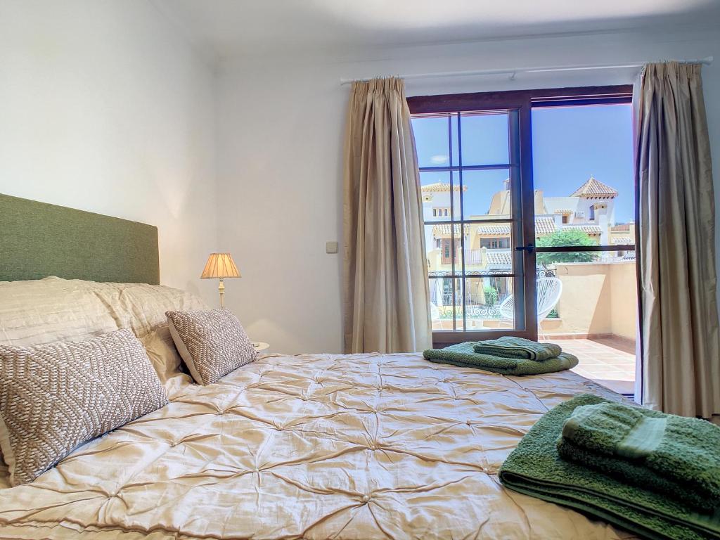 A bed or beds in a room at La Manga Club - Las Atalayas 7709