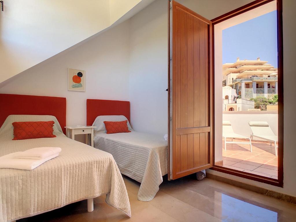 A bed or beds in a room at La Manga Club - Las Atalayas 7709