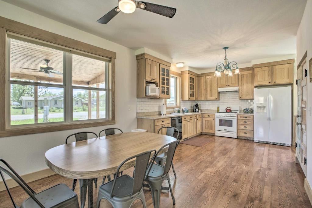 a kitchen with a table and chairs and a refrigerator at Idyllic Gem Screened Porch, half Mi to River! in Thermopolis