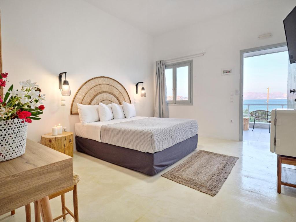 Schlafzimmer mit einem Bett und Meerblick in der Unterkunft Bonatsa Beach House in Kimolos