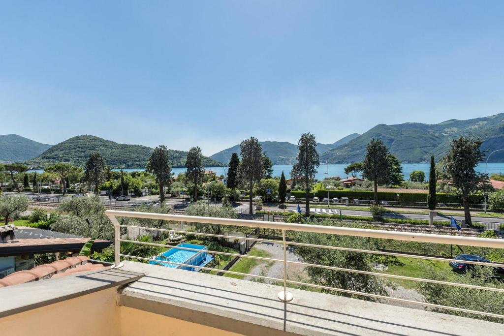 a balcony with a view of the water and mountains at Casa Caterina Mansarda vista Lago in Marone