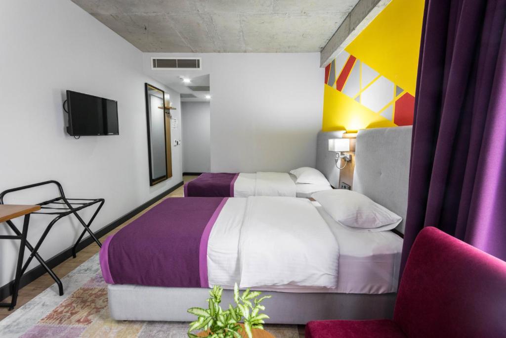 Postel nebo postele na pokoji v ubytování Hotel Adora