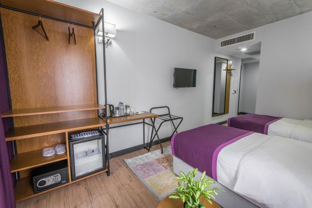 Postel nebo postele na pokoji v ubytování Hotel Adora