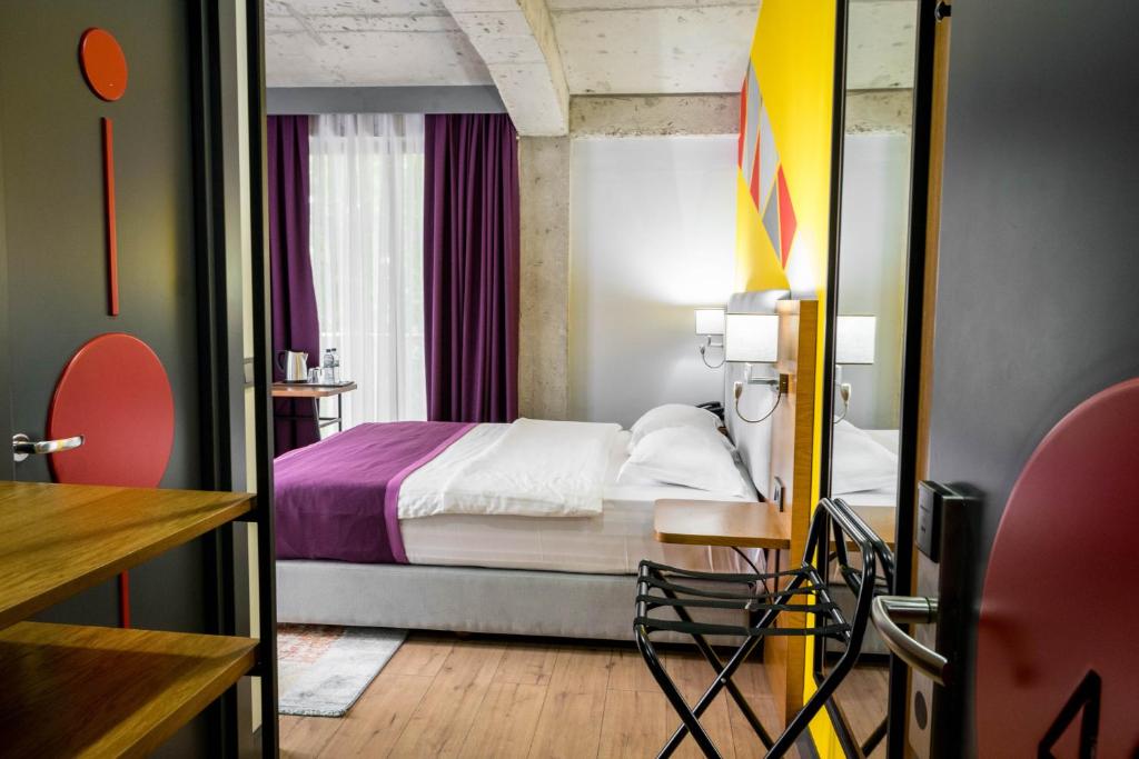 Postel nebo postele na pokoji v ubytování Hotel Adora