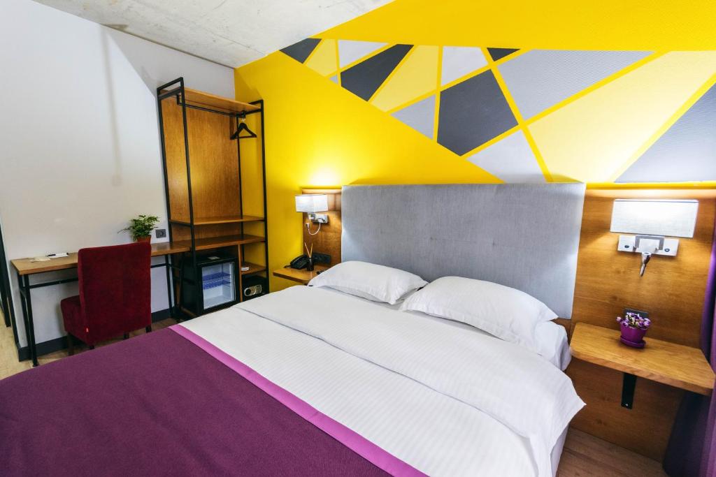 Postel nebo postele na pokoji v ubytování Hotel Adora