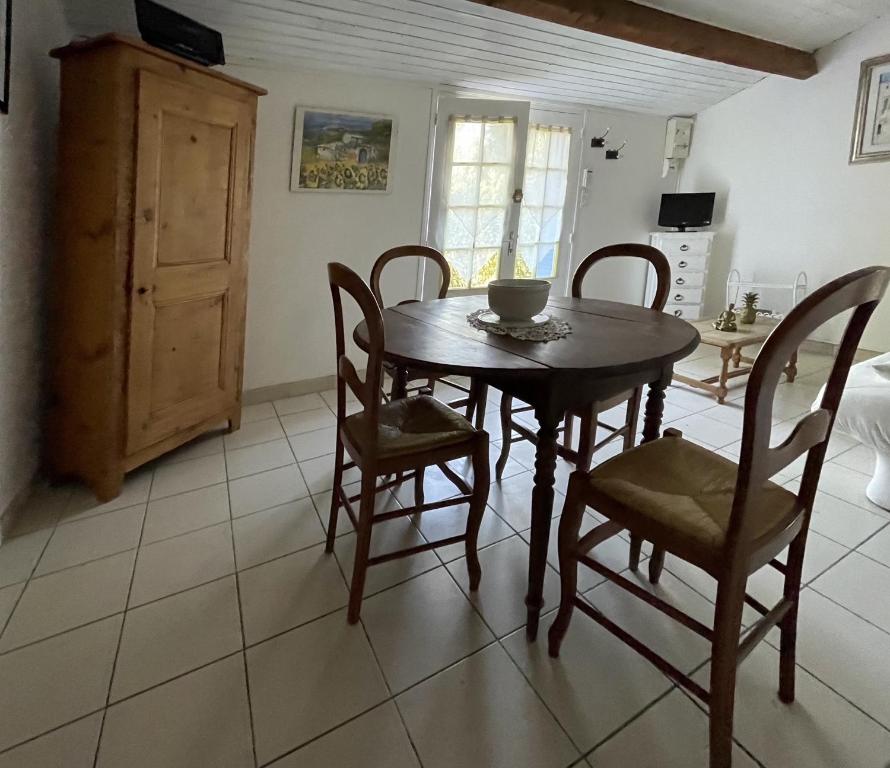 a dining room with a wooden table and chairs at Gîte en Drôme provençale in Les Granges-Gontardes