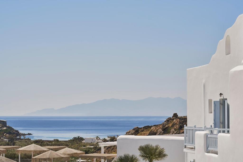 a view of the ocean from the side of a white building at Paradise View Hotel in Paradise Beach