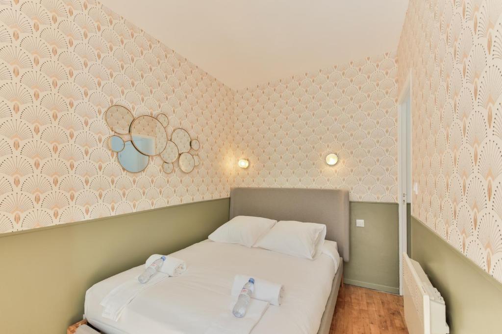 a bedroom with two beds and a wall with hearts at indépendant flat: canal st martin&amp;trains stations! in Paris