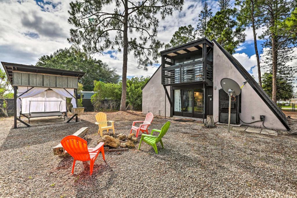 ein kleines Haus mit bunten Stühlen davor in der Unterkunft Authentic Clewiston Home with Outdoor Game Room in Clewiston