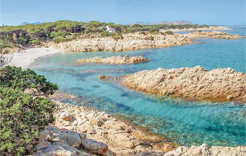 a view of a beach with rocks and water at Quadri in Orosei