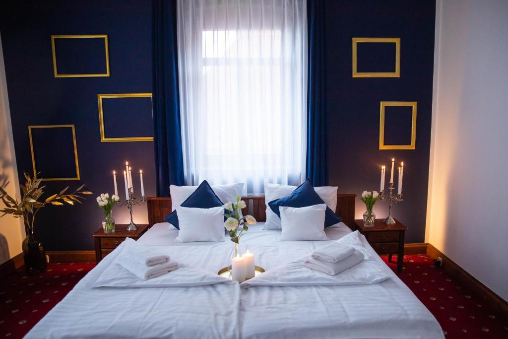a bedroom with a large bed with a candle on it at Piastowski26 in Jelenia Góra