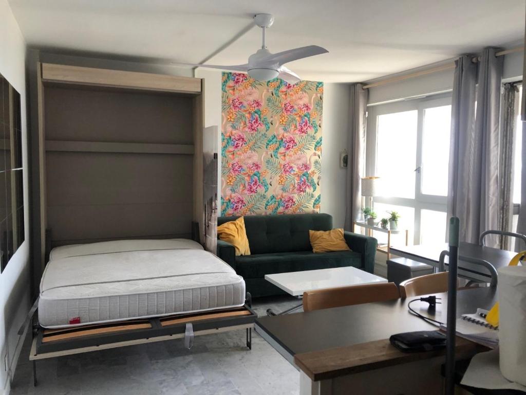 un salon avec un lit et un canapé dans l'établissement T 1 VUE MER 180 D° TEMPLE DU SOLEIL, à La Grande Motte