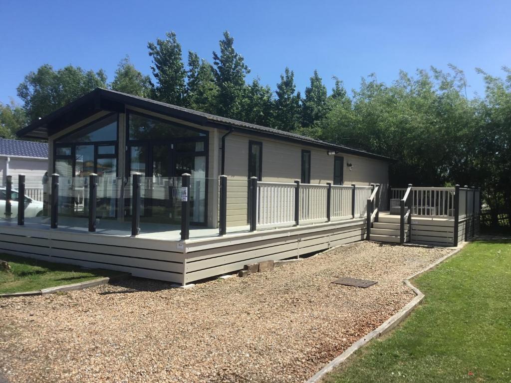 a mobile home with a screened in porch at Tuscany Lodge in Merston