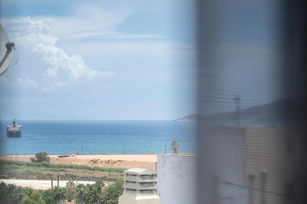a view of a beach and the ocean from a building at MK Apartment in Lavrio