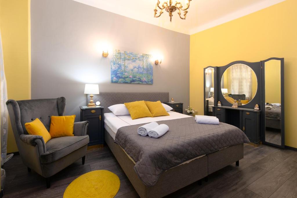 a bedroom with a bed and a chair and a mirror at Apartment Korzo Filodrammatica in Rijeka