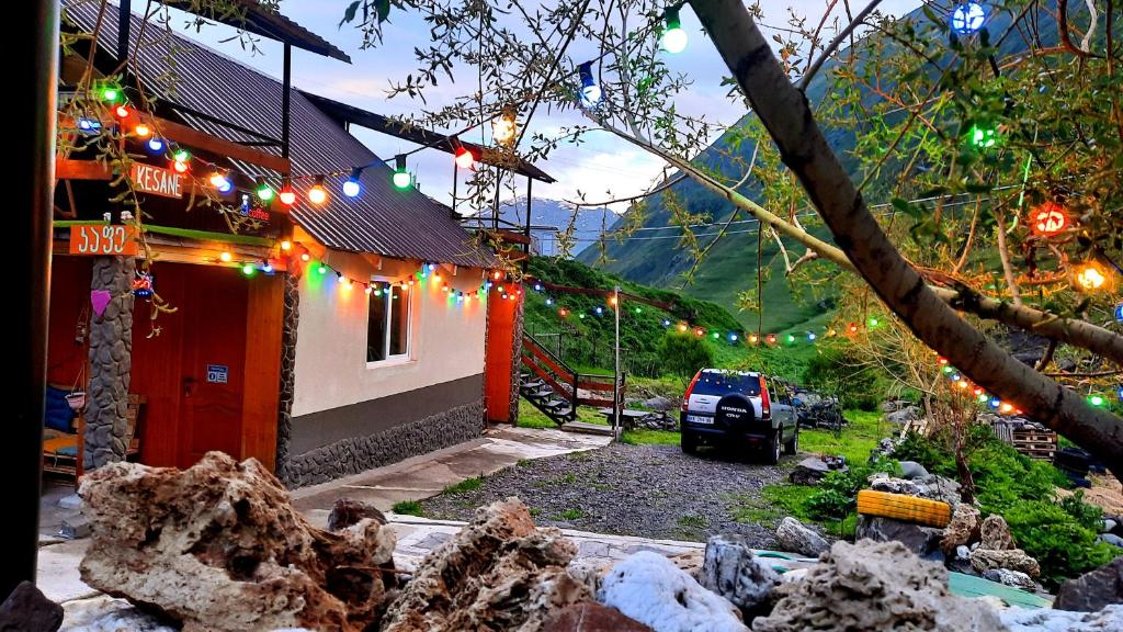 a house with christmas lights and a car parked next to it at Kesane in Jut'a