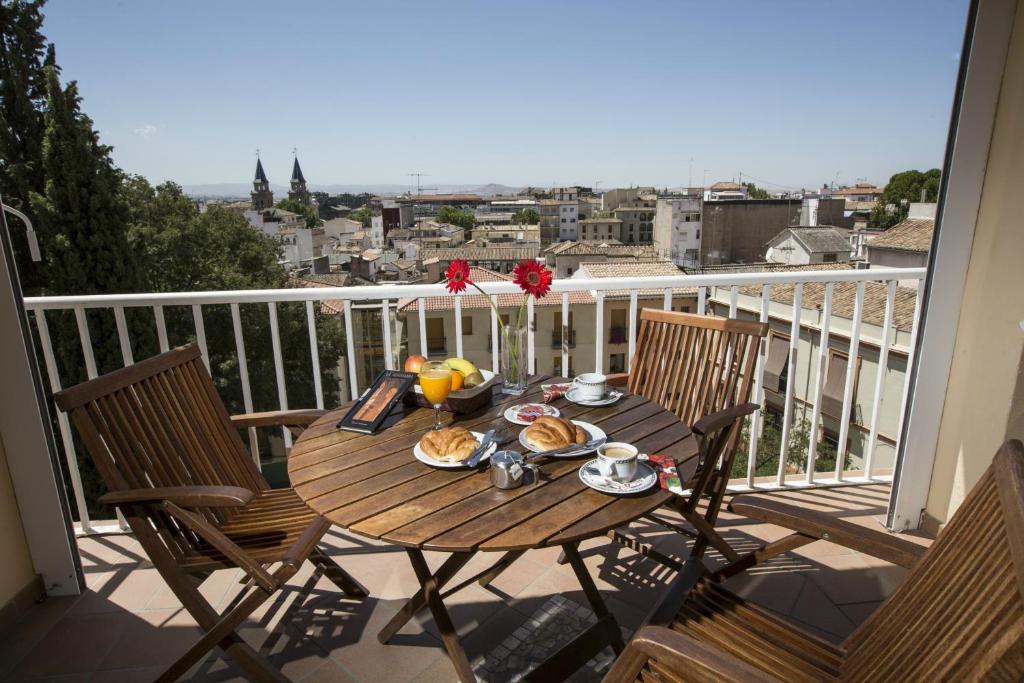 a table with food on top of a balcony at Hotel Carlos V in Granada