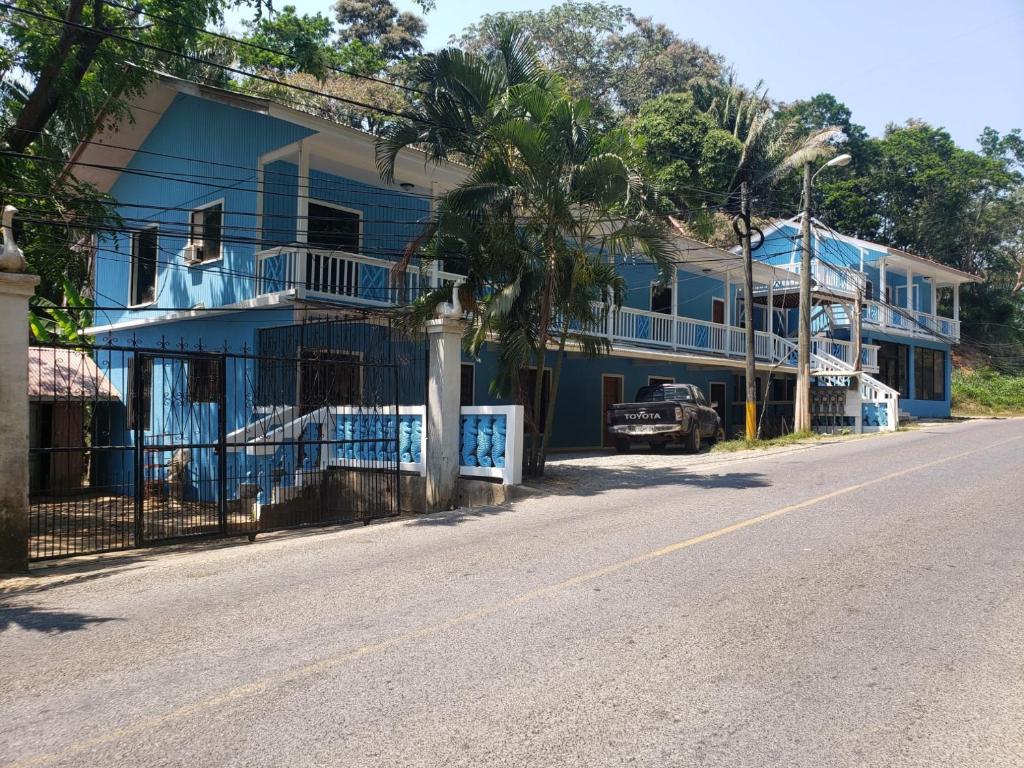 a blue house on the side of a street at Bliss on the Bay family in West End