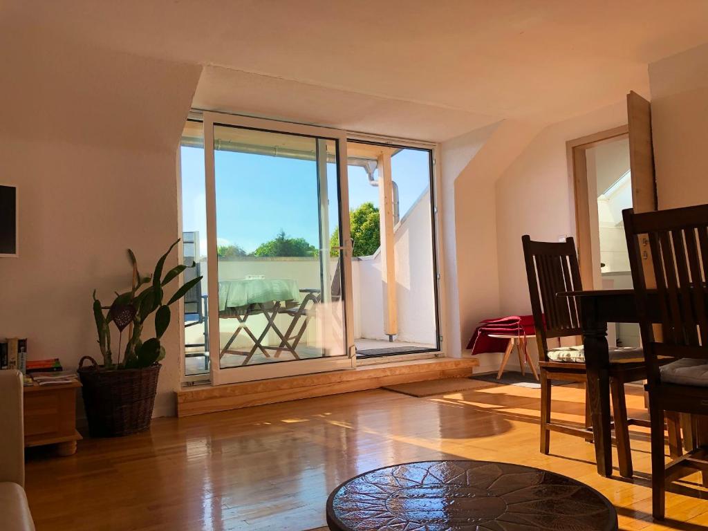 a living room with a large window and a table at Ferienwohnung Marienhöhe in Nördlingen