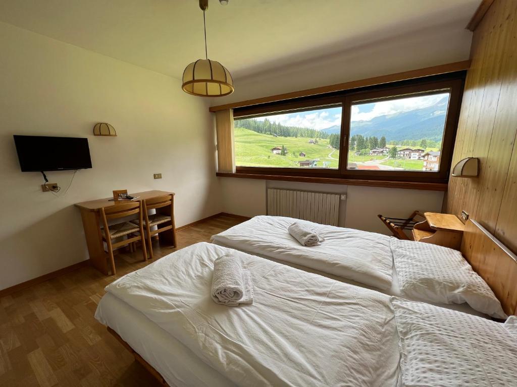 Postel nebo postele na pokoji v ubytování Hotel D'La Varda