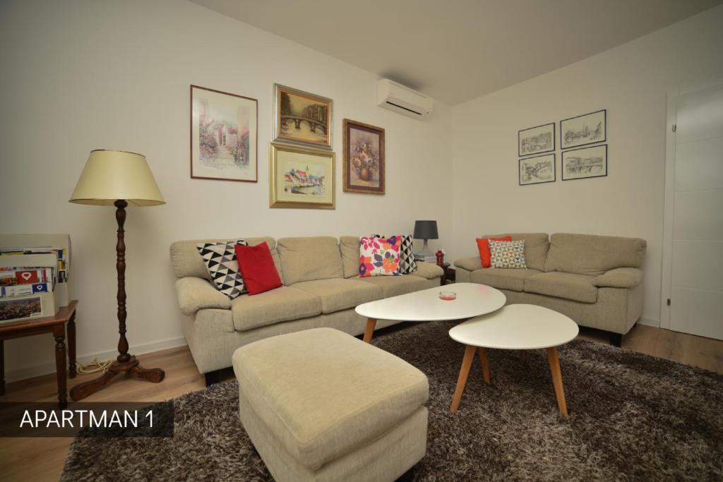 a living room with a couch and a table at Apartman Slatki dom 1 in Sarajevo