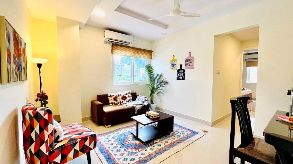 a living room with a couch and a table at Olive Service Apartments Gachibowli in Hyderabad
